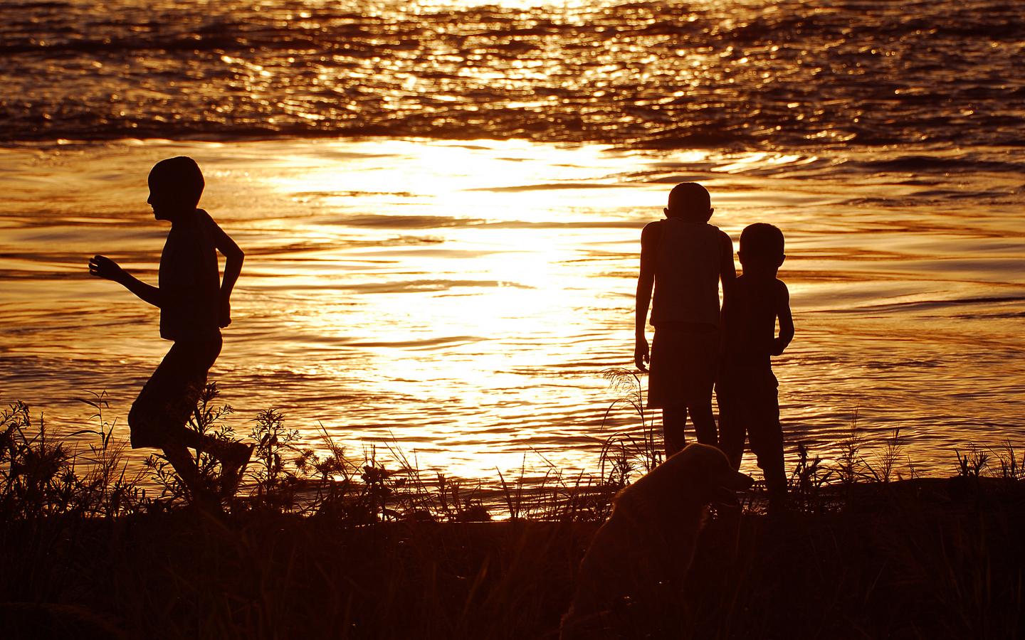Trois enfants indigènes et un chien autour du lac Tarapoto en Amazonie du Nord 