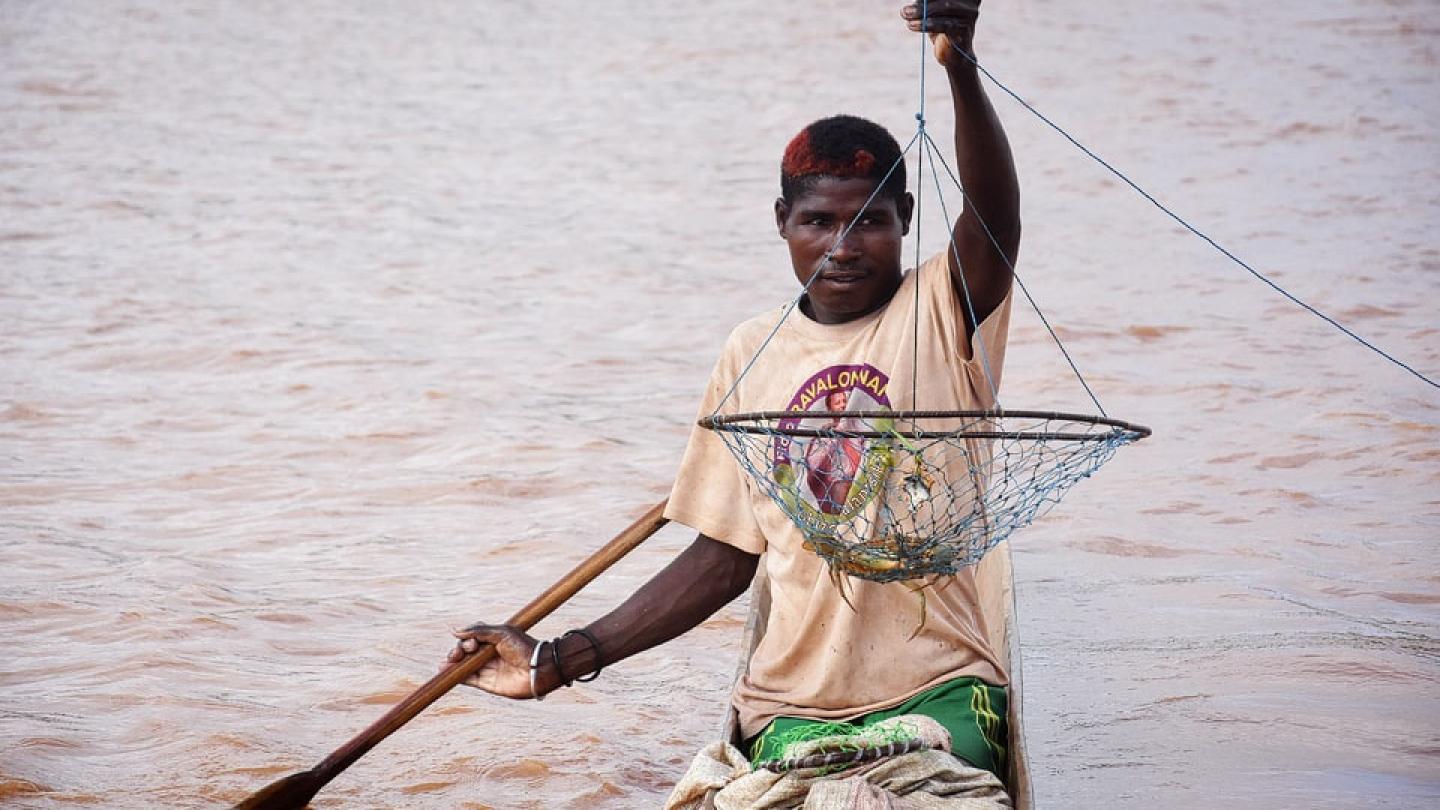 Homme utilisant une balance à crabes pour pêcher, Madagascar