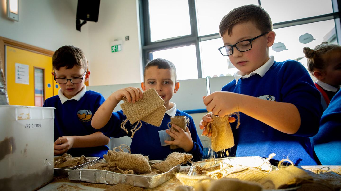 Equipes d'enfants bénévoles préparant les sac de graines d'herbiers marins au Royaume-Uni